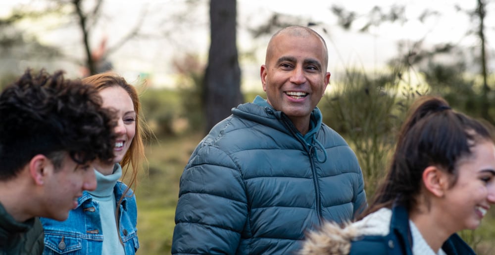 happy foster family walking in the park