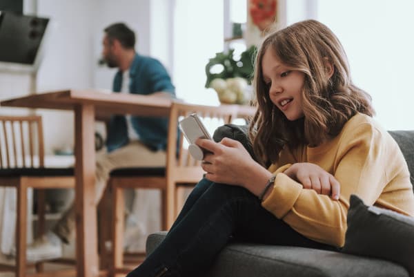 Girl using cellphone at home