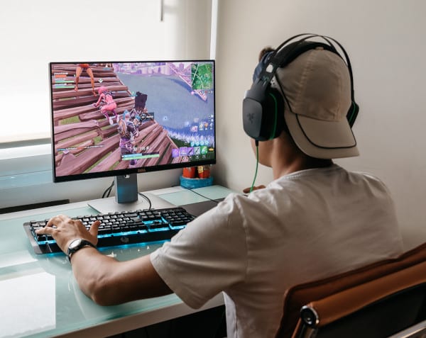 Teenager playing video game on PC