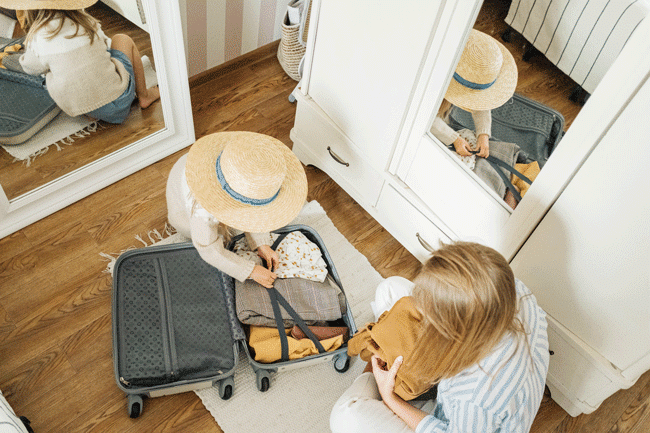 child packing suitcase